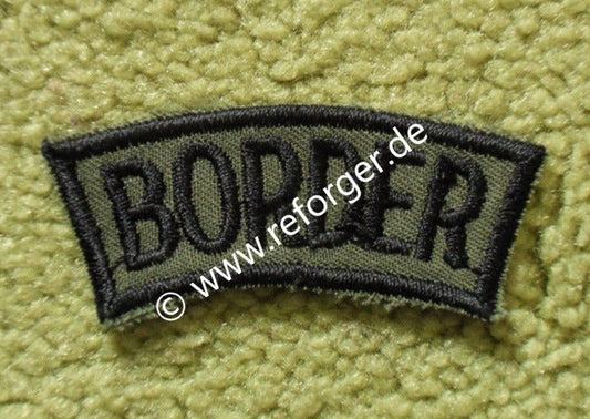 Olivgrünes Stoffabzeichen, bestickt mit dem Schriftzug "Border" – US-Army Mützenabzeichen